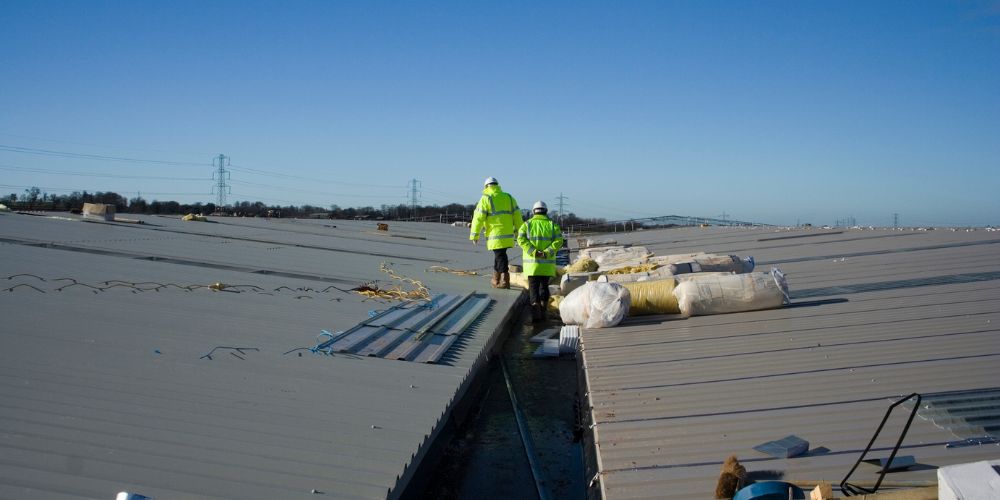 Two men inspecting the roof