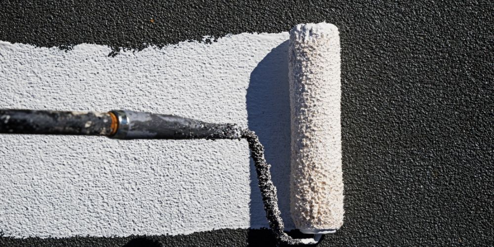 A paint roller with white paint.