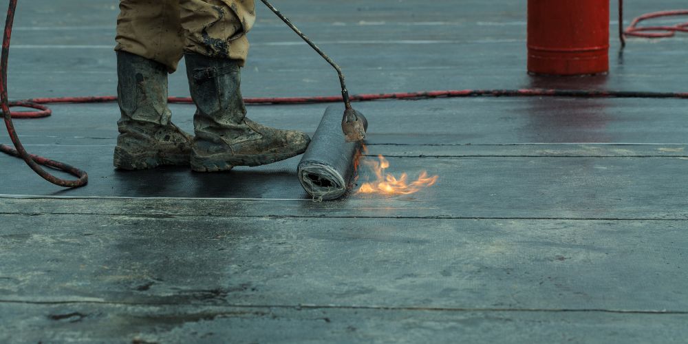 Man installing roof waterproofing